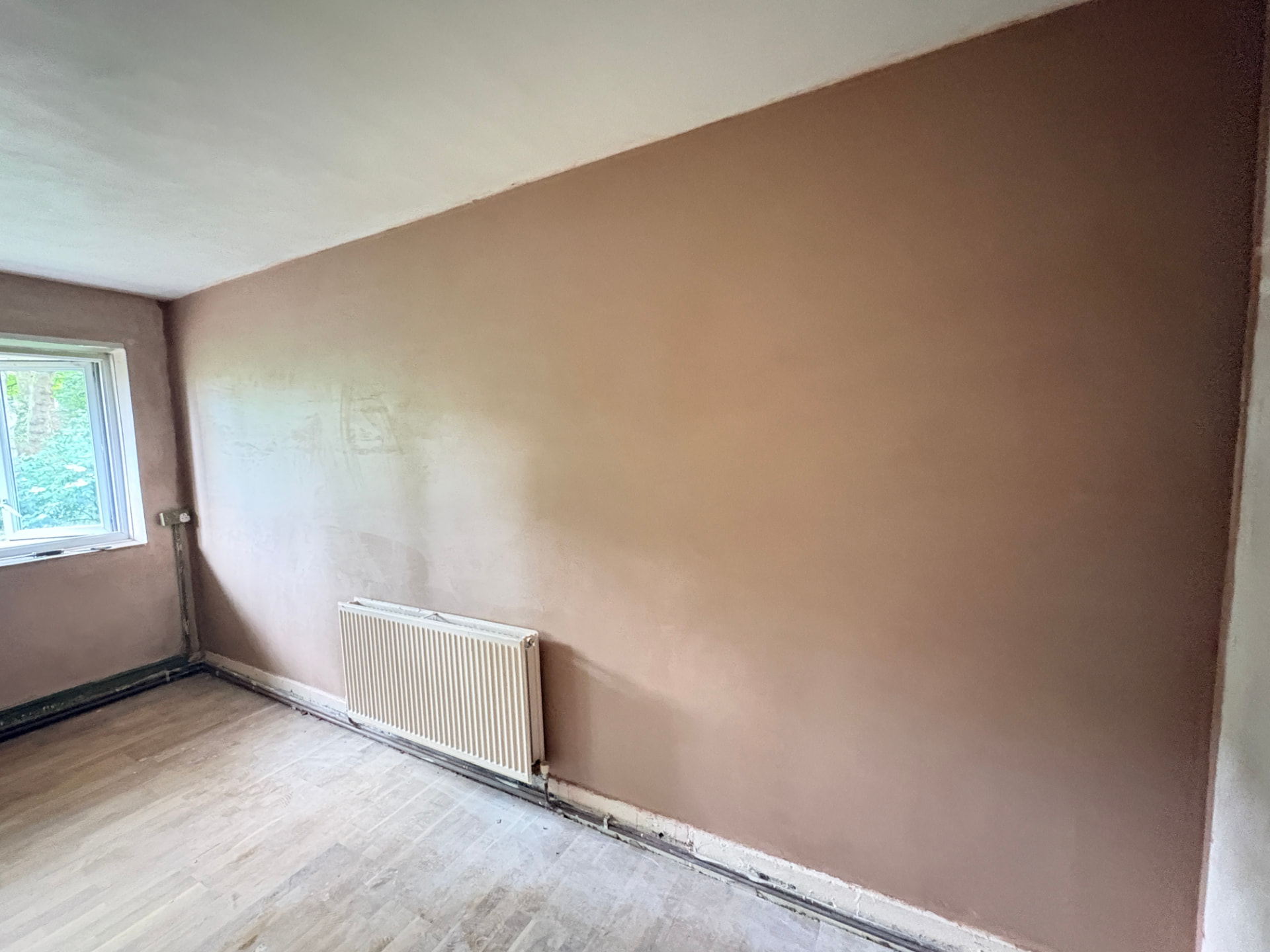 Bedroom wall skim finish beside window