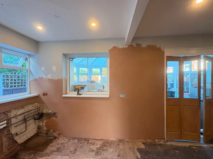 Kitchen wall replastered around window, Manchester