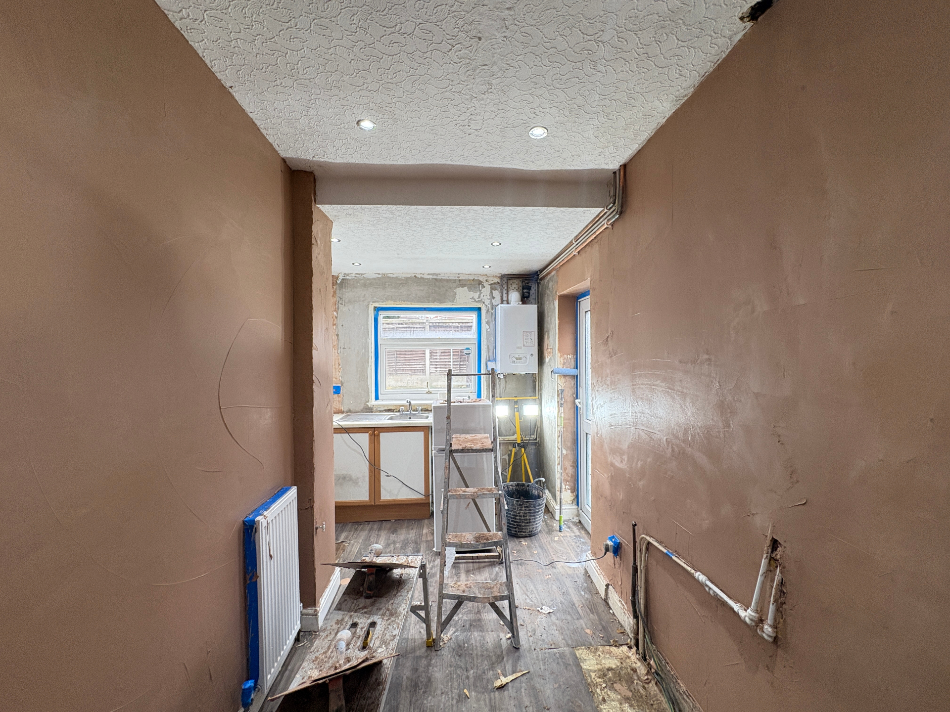Living room after — freshly skimmed walls and reveals