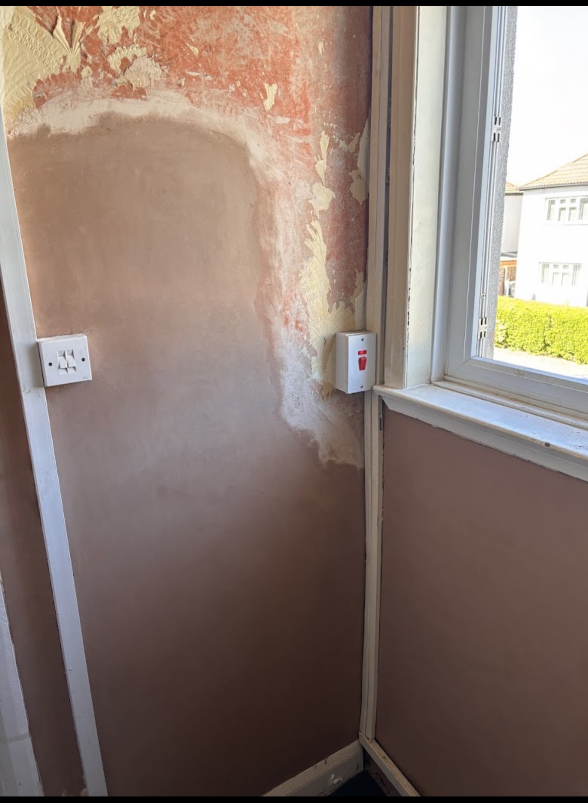 Stairwell repair after — clean finish by window reveal