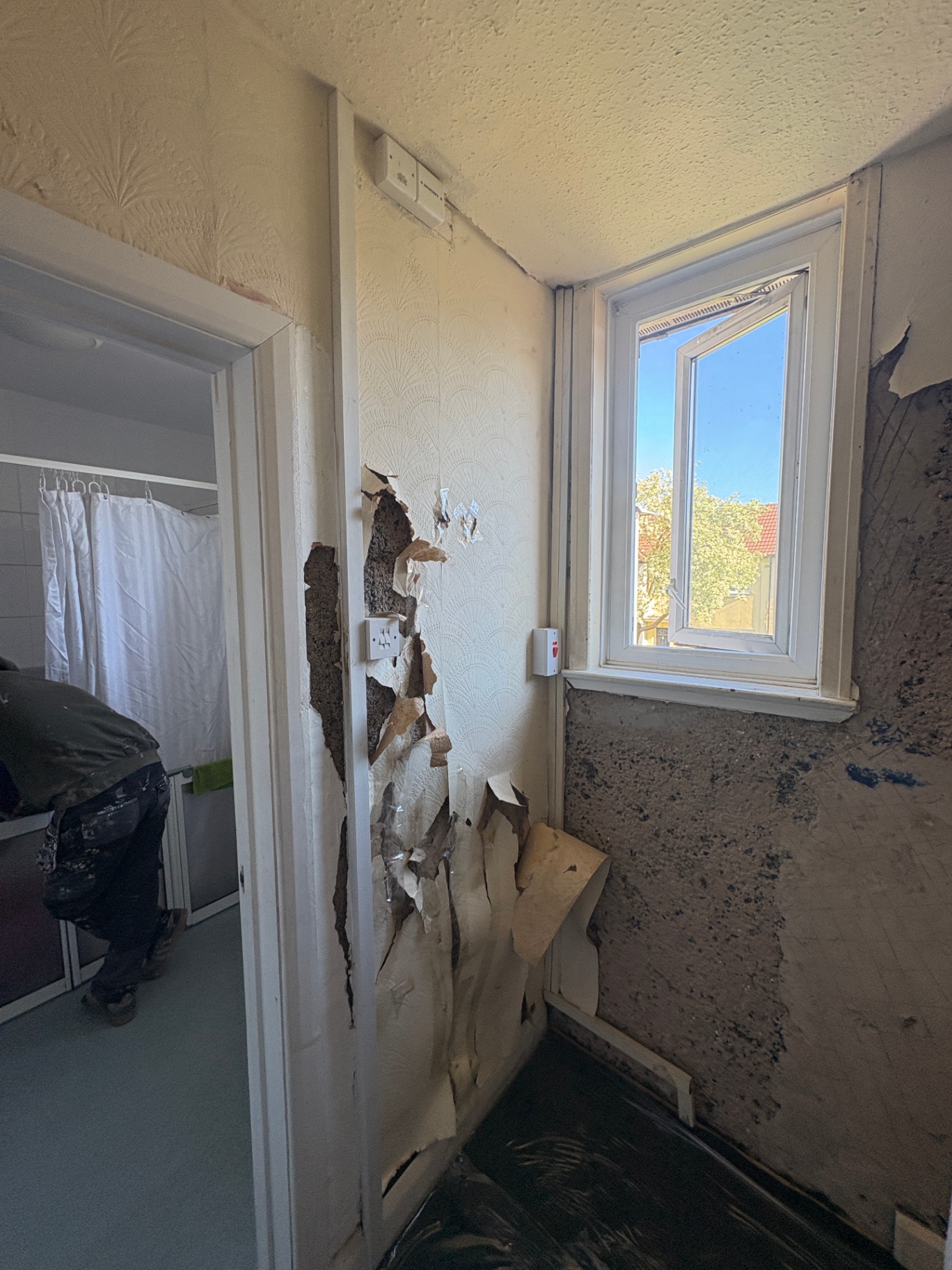 Stairwell repair before — blown plaster and wall damage
