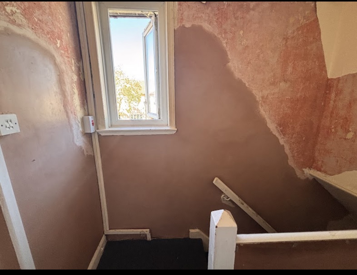 Stairwell repair after — smooth bonded finish